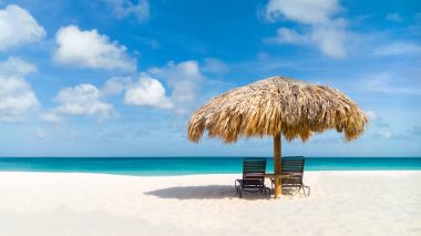 Straw umbrella on Eagle Beach, Aruba clipart