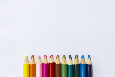 Beyaz arka plan üzerinde renkli kalemler. Eğitim kavramı