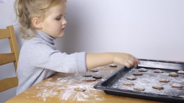 Little girl with handmade heart shaped cookies — Stock Video