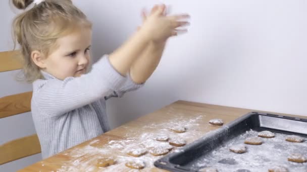 Young girl making handmade heart shaped cookies — Stock Video