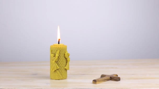 Κερί με Ορθόδοξο σταυρό στο ξύλινο τραπέζι — Αρχείο Βίντεο