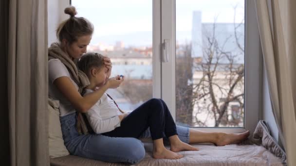 Žena měřící teplotu své malé dcery — Stock video