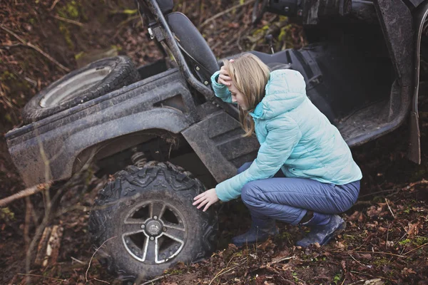 Woman shocked by an estremal ride on UTV. Checks the status of a buggy that has rolled down a mountain into a ditch