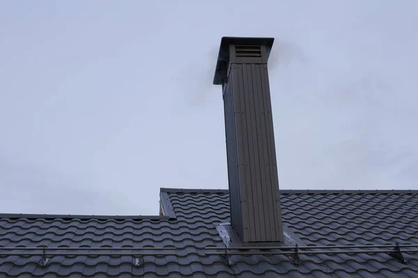 New roof and pipe made of metal and black — Stock Photo, Image