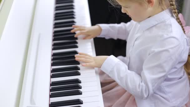 Talented child plays the piano. Masterly performance of music — Wideo stockowe