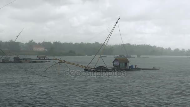 Lake houseboats with Chinese fishing nets on heavy rain day — Stock Video