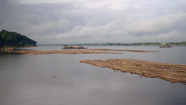 Ferry boats passing each other on river; Bamboo floors on water in the foreground — Stock Video