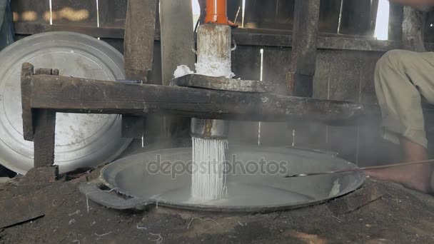 Man pressing rice dough; Rice noodles are cooked in boiling water straightaway — Stock Video