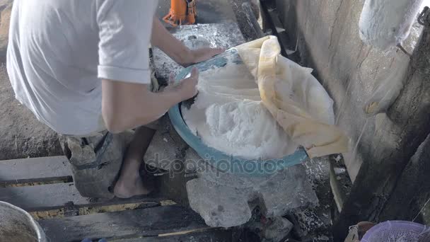 Close-up on man filling noodle pressing machine with rice dough — Stock Video