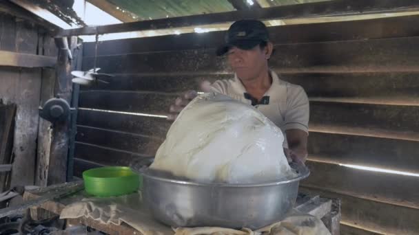 Человек руками месит рисовое тесто и медленно добавляет воду (крупным планом) ) — стоковое видео