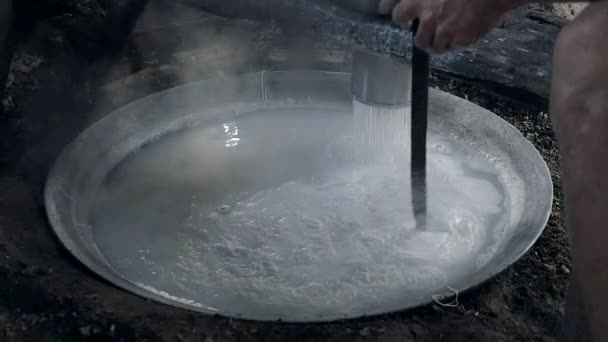 Rice noodles fall directly into boiling water for cooking ( close up ) — Stock Video