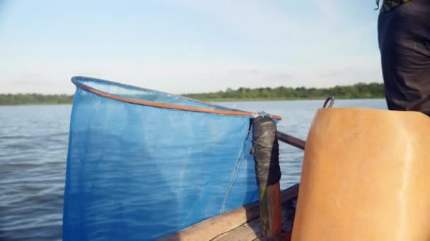 Prawn fisherman throwing freshly caught shrimps into net hung from boat (close-up) — Stock Video