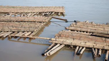 Gelecekteki köprü sahasında suda saklanan bambu direği yığınları