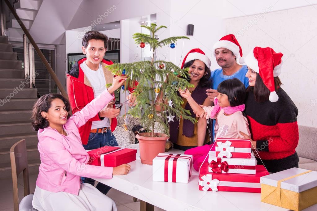 family christmas holidays and people concept happy indian kids decorating christmas tree - People Decorating A Christmas Tree family christmas holidays and people concept happy indian kids decorating christmas tree - People Decorating A Christmas Tree