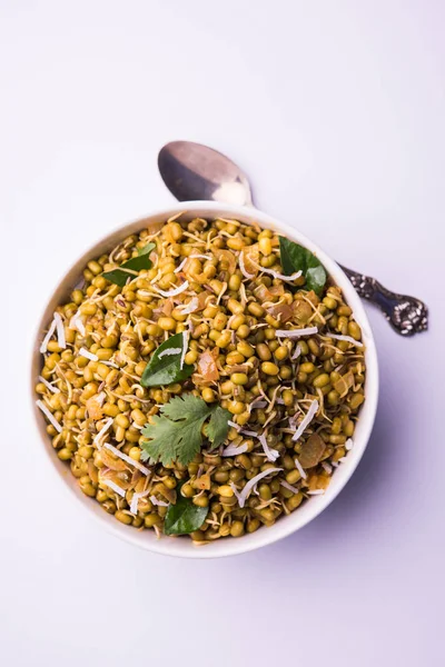 Mugachi Usal ya da Baharatlı Moong Sabzi 'yi filizlendirdi. Renkli arka planda bir kasede servis edilmiş. Seçici odak