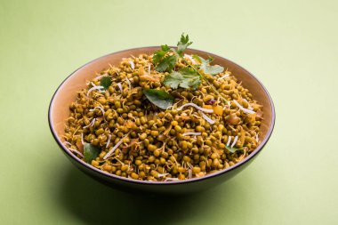 Mugachi Usal ya da Baharatlı Moong Sabzi 'yi filizlendirdi. Renkli arka planda bir kasede servis edilmiş. Seçici odak