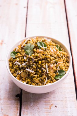 Mugachi Usal ya da Baharatlı Moong Sabzi 'yi filizlendirdi. Ahşap arka planda bir kasede servis edilmiş. Seçici odak