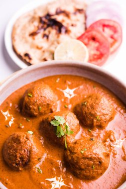 Kızartma tavasında taze pişirilmiş baharatlı patates körisi mi yoksa tandır roti veya naan veya Hint ekmeği veya chapati ve yeşil salata ile servis edilen sıcak ve baharatlı Dum aloo mu?