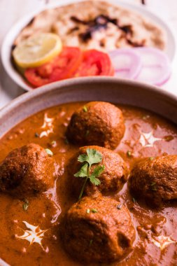 Kızartma tavasında taze pişirilmiş baharatlı patates körisi mi yoksa tandır roti veya naan veya Hint ekmeği veya chapati ve yeşil salata ile servis edilen sıcak ve baharatlı Dum aloo mu?