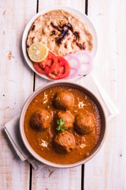 Kızartma tavasında taze pişirilmiş baharatlı patates körisi mi yoksa tandır roti veya naan veya Hint ekmeği veya chapati ve yeşil salata ile servis edilen sıcak ve baharatlı Dum aloo mu?