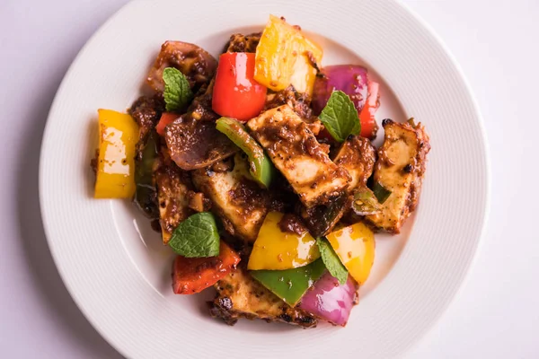 Kırmızı biber ya da baharatlı süzme peynir, kapsiyum ve soğanla servis edilir, favori Hint başlangıç menüsü, seçici odaklanma.