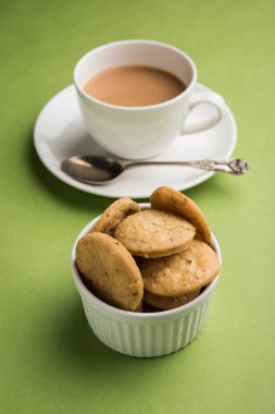 Baharatlı kızarmış mathri veya Hint bir aperatif olan mathari bir bardak çay, seçici odak ile servis