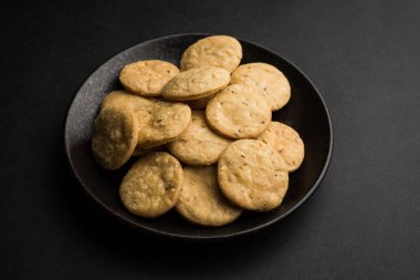 Baharatlı kızarmış mathri veya Hint bir aperatif olan mathari bir bardak çay, seçici odak ile servis