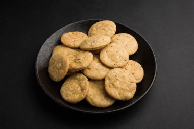 Baharatlı kızarmış mathri veya Hint bir aperatif olan mathari bir bardak çay, seçici odak ile servis