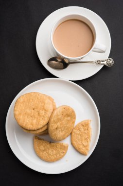 Baharatlı kızarmış mathri veya Hint bir aperatif olan mathari bir bardak çay, seçici odak ile servis