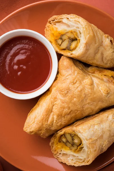 stuffed vegetable or veg puff or puf or samosa, famous indian snack menu, served with hot tea, selective focus