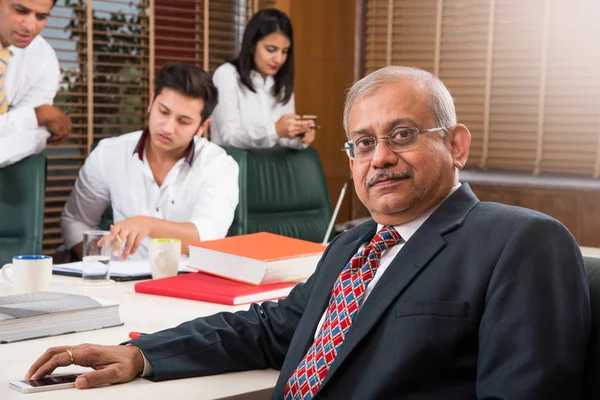 Indian business people working in the office with laptop, papers, meetings, presentations and discussions, business concept