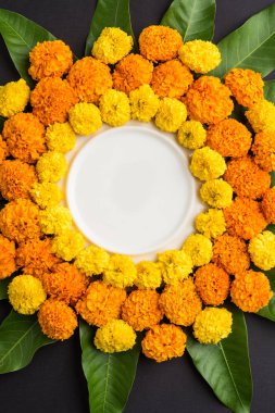 kadife çiçeği veya zendu çiçek ve mango kullanılarak yapılan çiçek rangoli kopya alanı orta, seçici odak ile siyah arka plan üzerinde bırakır