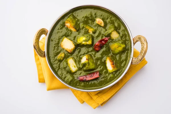 Indian curry dish - Palak paneer made up of  spinach and cottage cheese, served in white bowl, selective focus