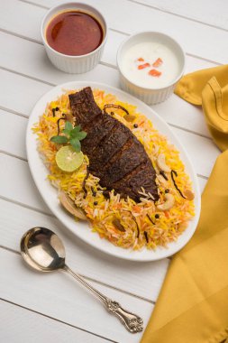 Biryani balık ya da balık pirinç - popüler Hint vejetaryen Sigara tarifi balık yapılan taze otlar Hint baharatlarla Marine ve pişmiş ile Basmati pirinç, seçici odak