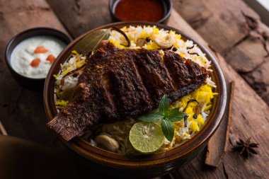 Biryani balık ya da balık pirinç - popüler Hint vejetaryen Sigara tarifi balık yapılan taze otlar Hint baharatlarla Marine ve pişmiş ile Basmati pirinç, seçici odak