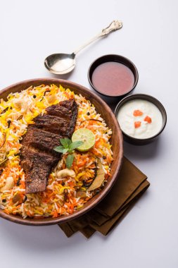 Biryani balık ya da balık pirinç - popüler Hint vejetaryen Sigara tarifi balık yapılan taze otlar Hint baharatlarla Marine ve pişmiş ile Basmati pirinç, seçici odak