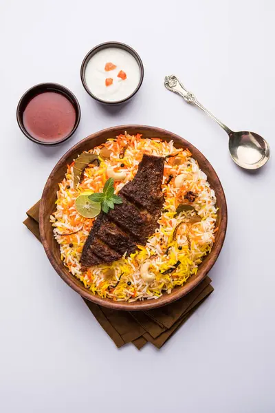 Biryani balık ya da balık pirinç - popüler Hint vejetaryen Sigara tarifi balık yapılan taze otlar Hint baharatlarla Marine ve pişmiş ile Basmati pirinç, seçici odak