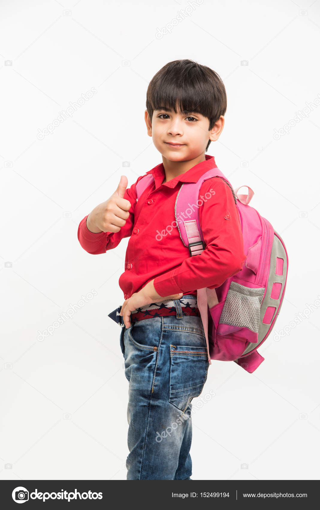 Indian smart kid in red shirt and denim jeans with school bag, standing  over white background Stock Photo by ©stockimagefactory.com 152499194