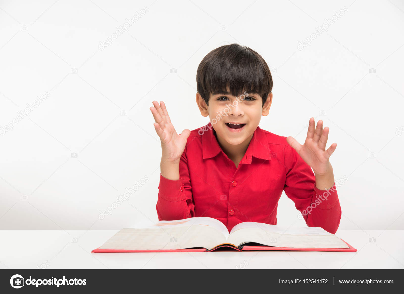 Indian cute little boy or kid reading book over study table, isolated over  white background — Stock Photo © stockimagefactory.com #152541472, image size:1600x1168