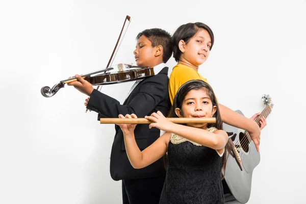 indian kids performing and singing while playing guitar, violin, flute, minor musical instrument etc in a band, isolated over white background