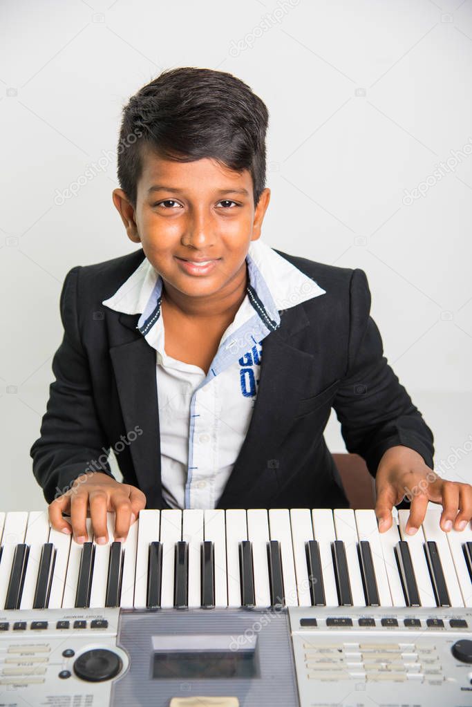 indian kids playing piano or keyboard, a musical instrument