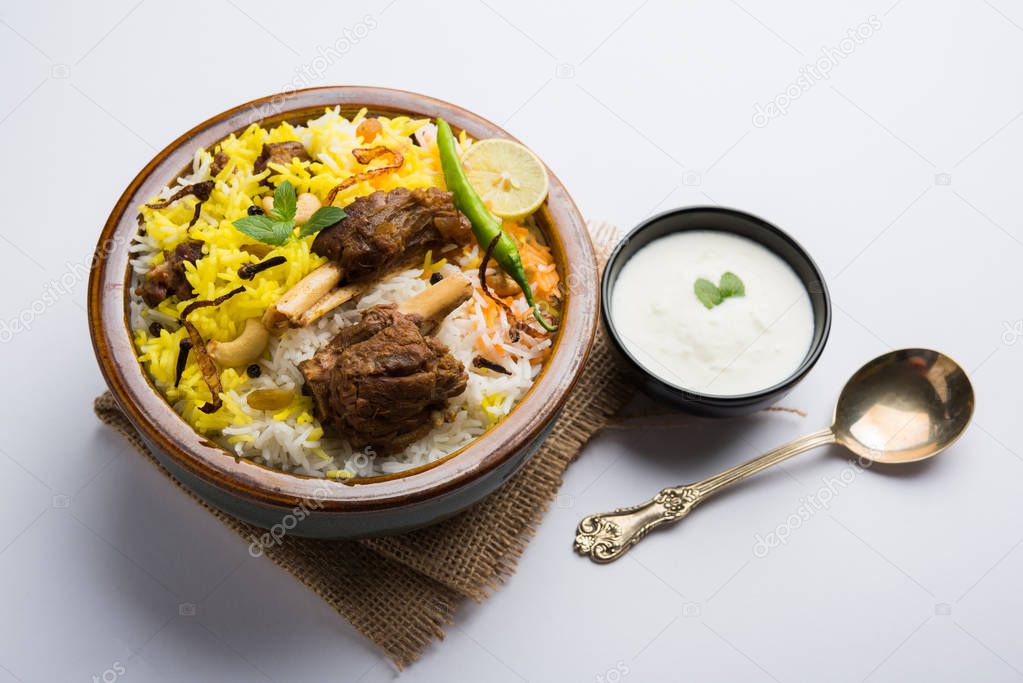 Kashmiri or Hyderabadi Mutton Gosht Biryani / Lamb Biryani / Mutton Biryani served with Yogurt dip, selective focus