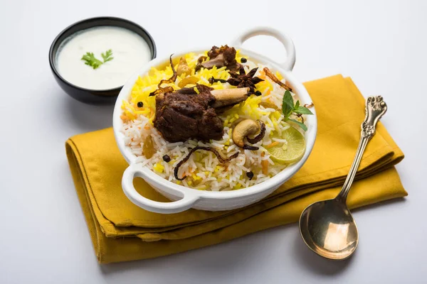 Kashmiri Mutton Gosht Biryani / Lamb Biryani / Mutton Biryani served with Yogurt dip, selective focus — Stock Photo, Image