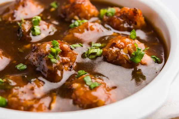 Gobi or veg Manchurian dry or with gravy - Popular street food of India made of cauliflower florets, selective focus