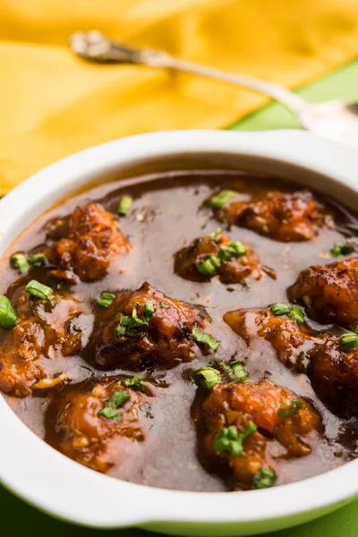 Gobi or veg Manchurian dry or with gravy - Popular street food of India made of cauliflower florets, selective focus