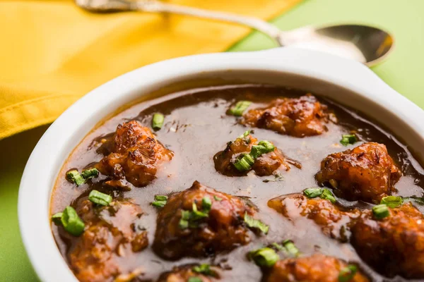 Gobi or veg Manchurian dry or with gravy - Popular street food of India made of cauliflower florets, selective focus