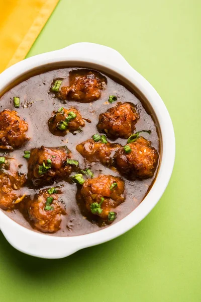 Gobi or veg Manchurian dry or with gravy - Popular street food of India made of cauliflower florets, selective focus