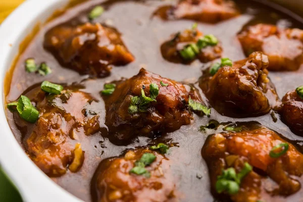 Gobi or veg Manchurian dry or with gravy - Popular street food of India made of cauliflower florets, selective focus