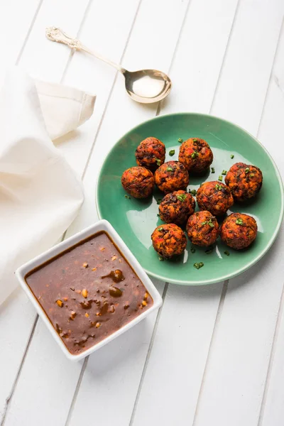 Gobi or veg Manchurian dry or with gravy - Popular street food of India made of cauliflower florets, selective focus