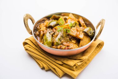 Hint baingan veya baigan ve aalu sabzi / Aloo Baingan tarifi / Hint baharatlı patlıcan ve patates köri, kadhai veya beyaz kase, seçici odak servis